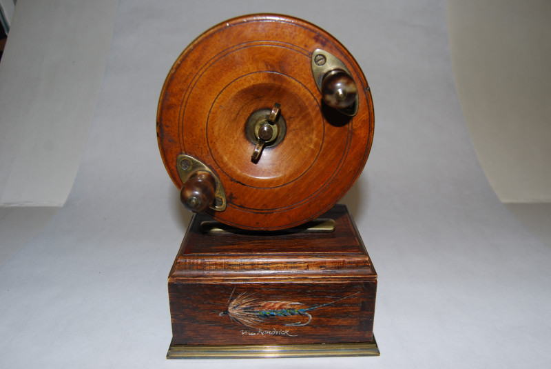 4 3/8 A.W. GAMAGE. LTD. NOTTINGHAM CENTREPIN REEL on Stand. Walnut Centrepin  reel mounted on wood base with compartment in lower base; Star Back brass  backplate; Circa 1890's. SOLD